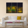 Multicolored dancing water jet fountain in the dark. multi panel canvas wall art