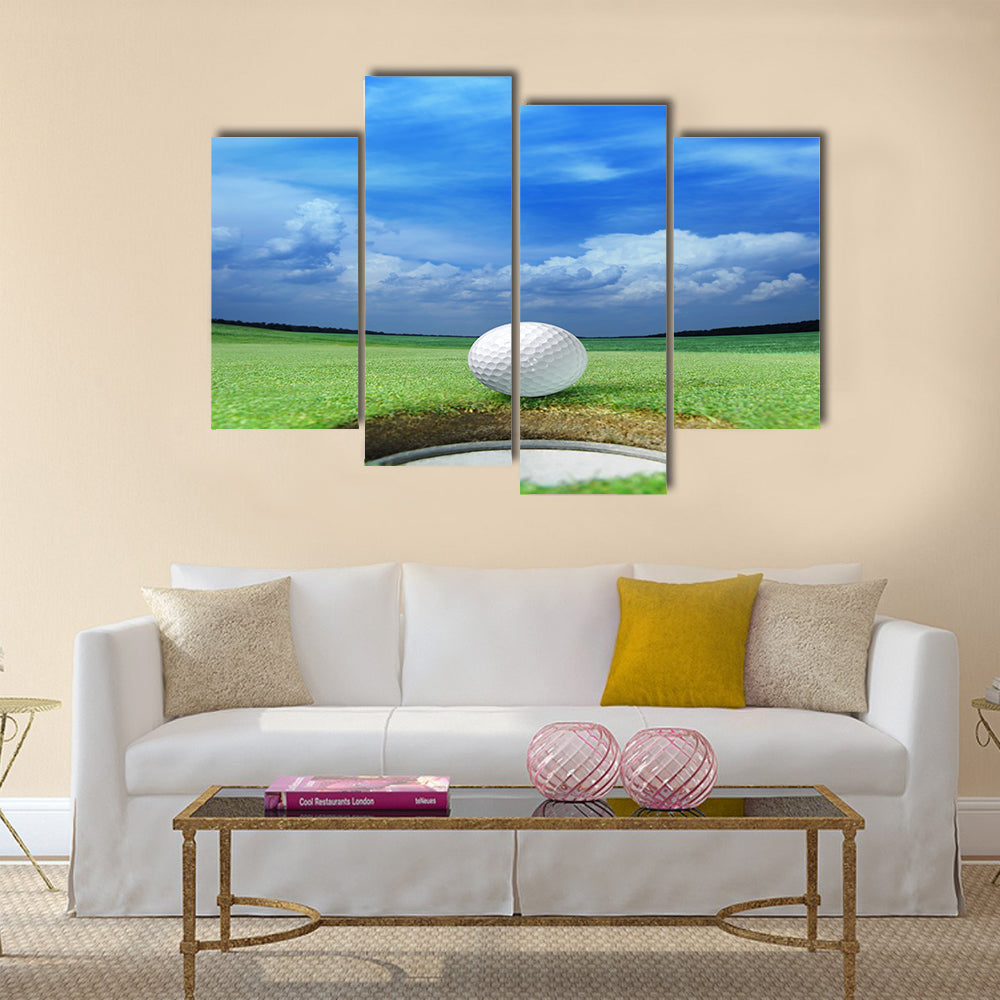 Golf ball on lip of cup of lovely beautiful golf course Multi panel canvas wall art