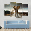 Single elephant walking in a road with the Sun from behind Multi panel canvas wall art