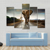 Single elephant walking in a road with the Sun from behind Multi panel canvas wall art