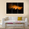 Military silhouettes fighting scene on war fog sky background Multi Panel Canvas Wall Art