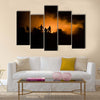 Military silhouettes fighting scene on war fog sky background Multi Panel Canvas Wall Art