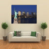 The landmark Statue of Liberty against the impressive New York City skyline Multi panel canvas Wall art