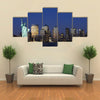 The landmark Statue of Liberty against the impressive New York City skyline Multi panel canvas Wall art