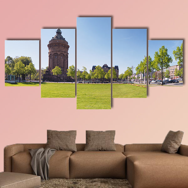 Fresh flower beds frame the green in front of the famous water wall art