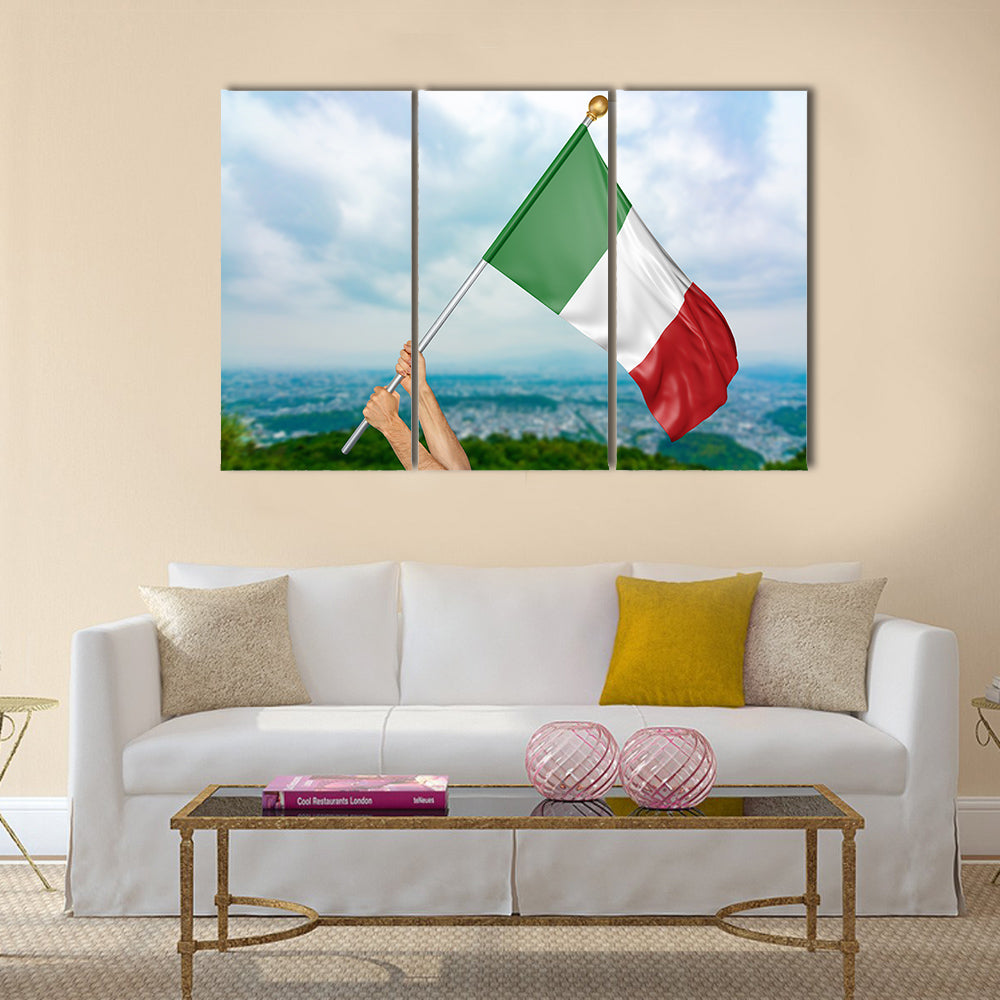Young man's hands proudly waving the Italy national flag in the sky Multi panel canvas wall art