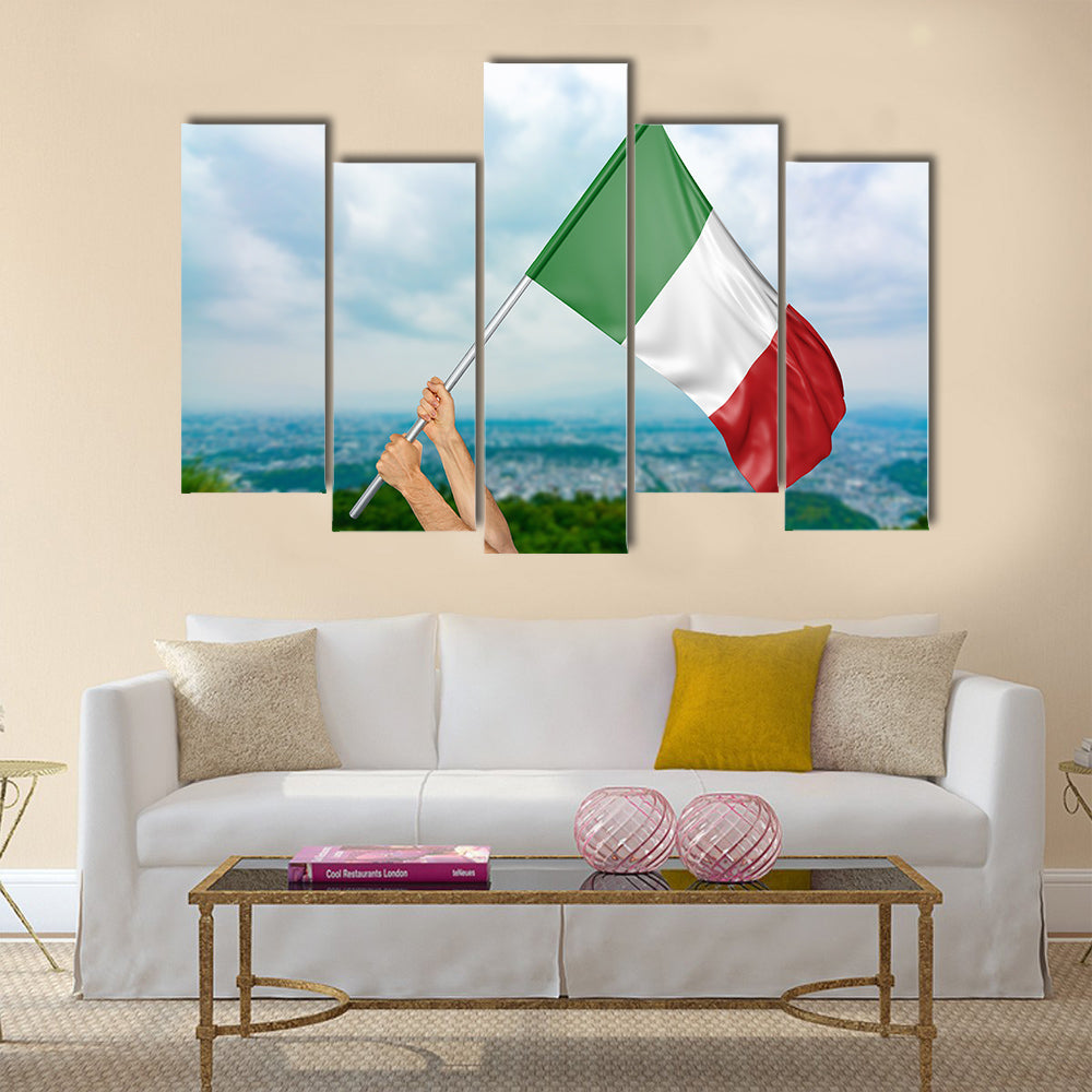 Young man's hands proudly waving the Italy national flag in the sky Multi panel canvas wall art