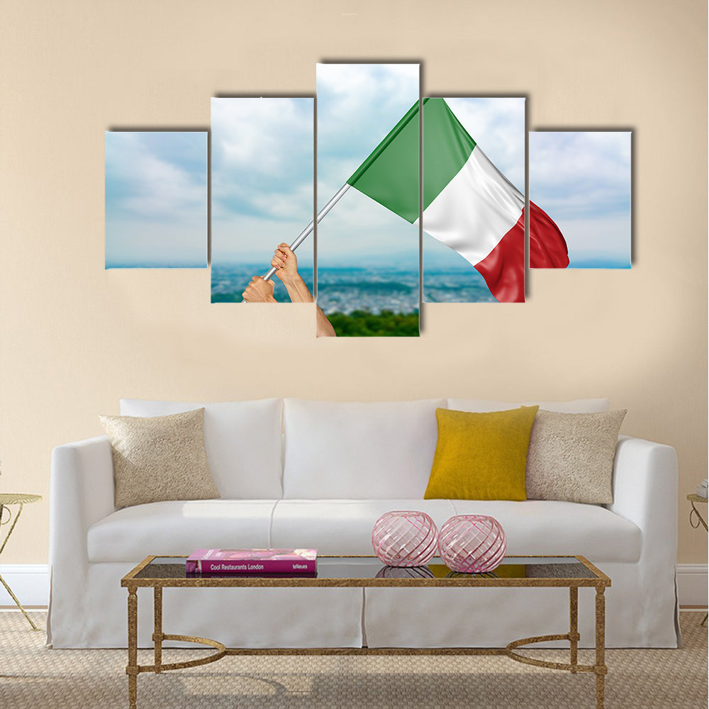 Young man's hands proudly waving the Italy national flag in the sky Multi panel canvas wall art