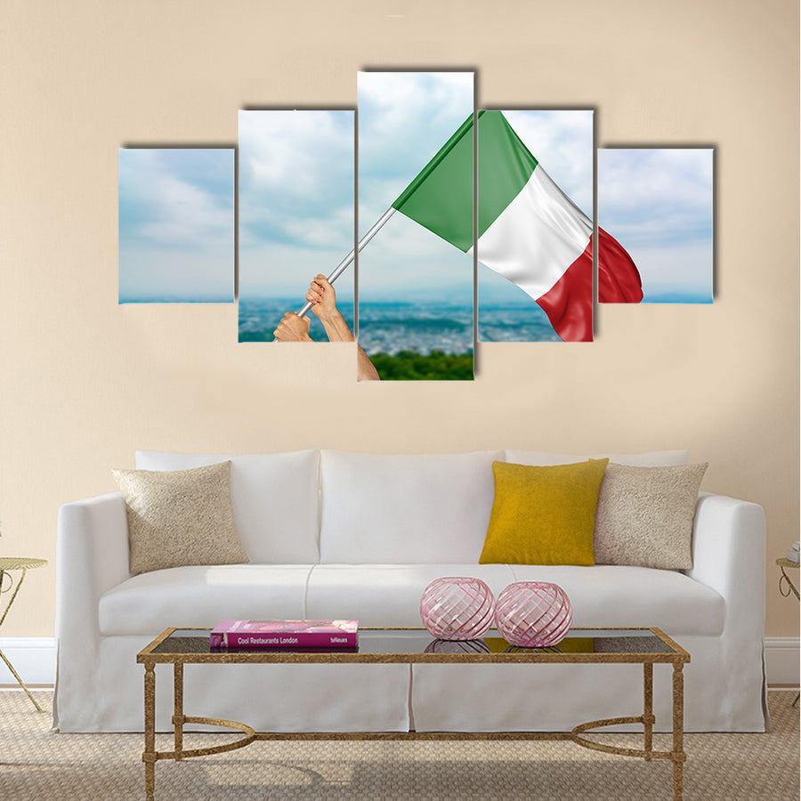 Young man's hands proudly waving the Italy national flag in the sky Multi panel canvas wall art