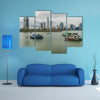 Fishing boats in a port with skyline of the Panama City multi panel canvas wall art