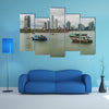 Fishing boats in a port with skyline of the Panama City multi panel canvas wall art