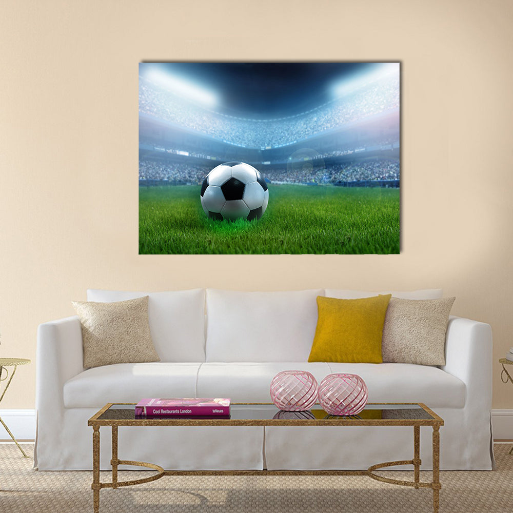 close up of a football ball on a full stadium Multi panel canvas wall art