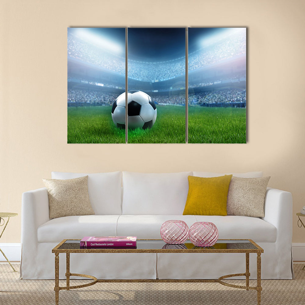 close up of a football ball on a full stadium Multi panel canvas wall art