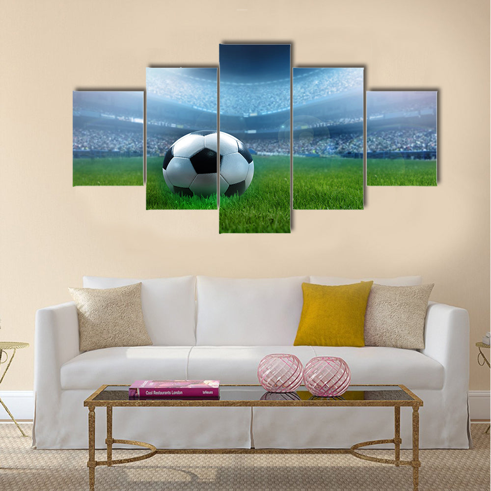 close up of a football ball on a full stadium Multi panel canvas wall art