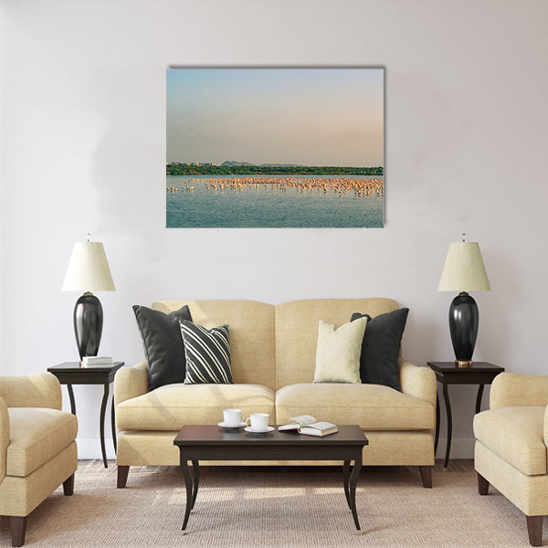 A Bunch of Flamingos Flying and Resting on a Lake Multi Panel Canvas Wall Art