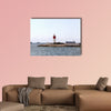 Red and white lighthouse near the fort of Christmas in Spain multi panel canvas wall art