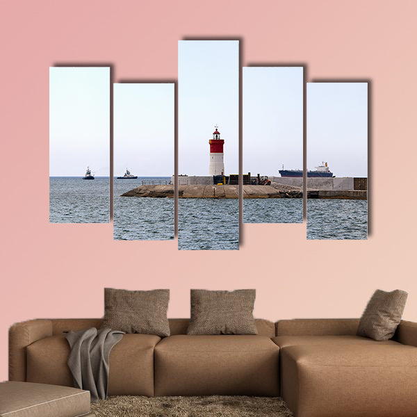 Red and white lighthouse near the fort of Christmas in Spain multi panel canvas wall art