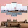 Red and white lighthouse near the fort of Christmas in Spain multi panel canvas wall art