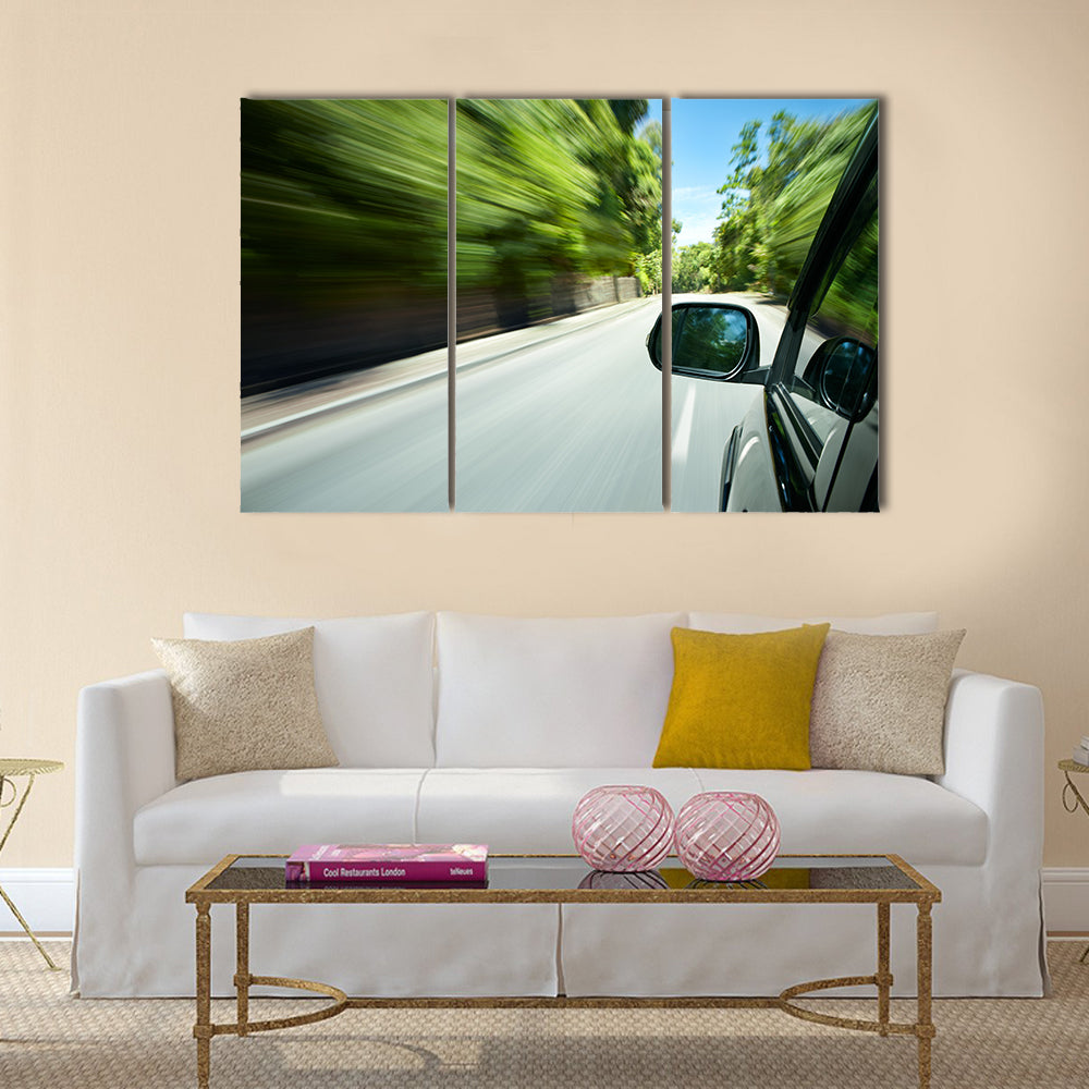 Car speeding on a straight road Multi panel canvas wall art