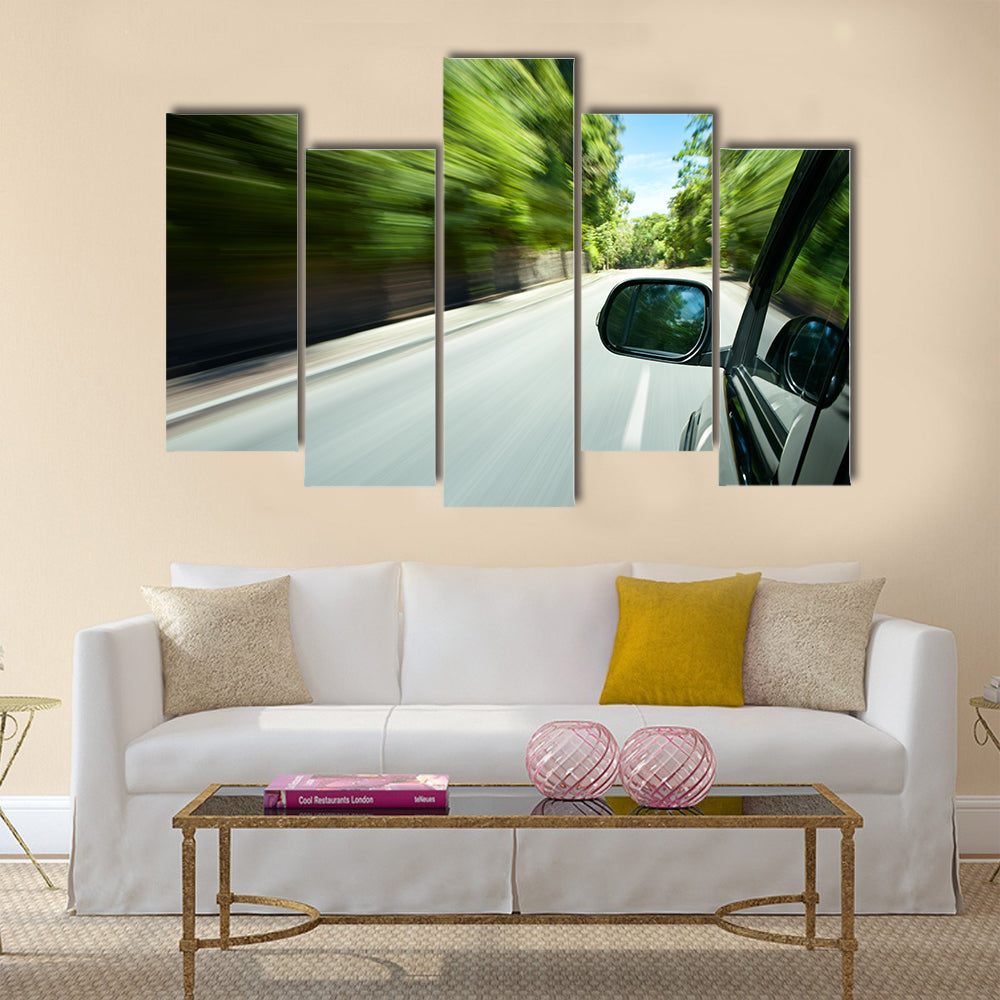 Car speeding on a straight road Multi panel canvas wall art