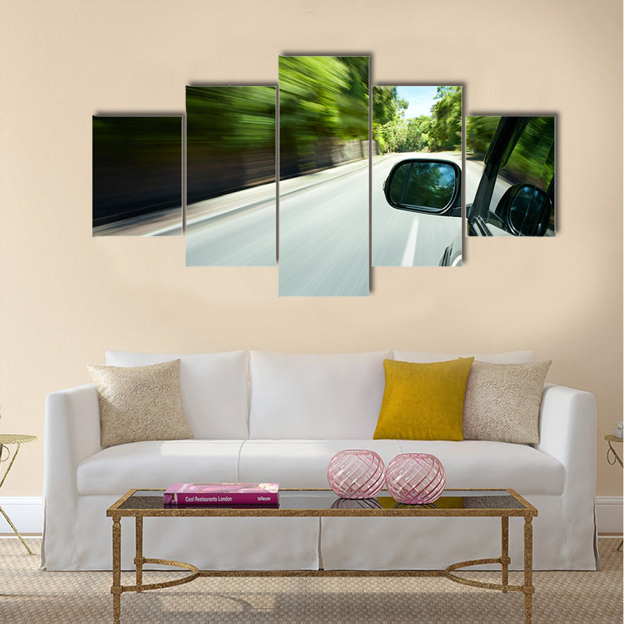 Car speeding on a straight road Multi panel canvas wall art