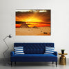 Camel caravan going through desert in front of pyramid at sunset Multi Panel Canvas Wall Art