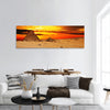 Camel caravan are in desert in front of pyramid at sunset panoramic canvas wall art