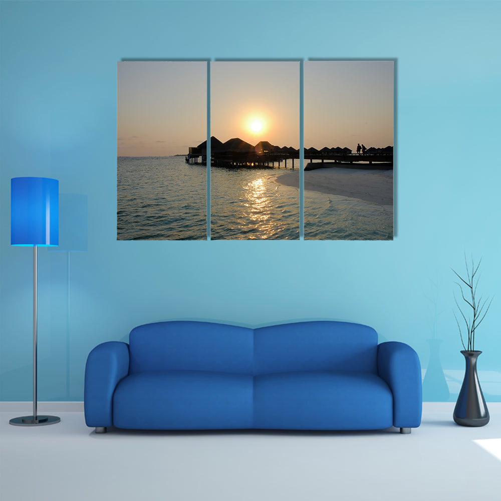 A Couple Enjoys At The Idyllic Sunset Stroll Along The Silhouetted Boardwalk Multi Panel Canvas Wall Art