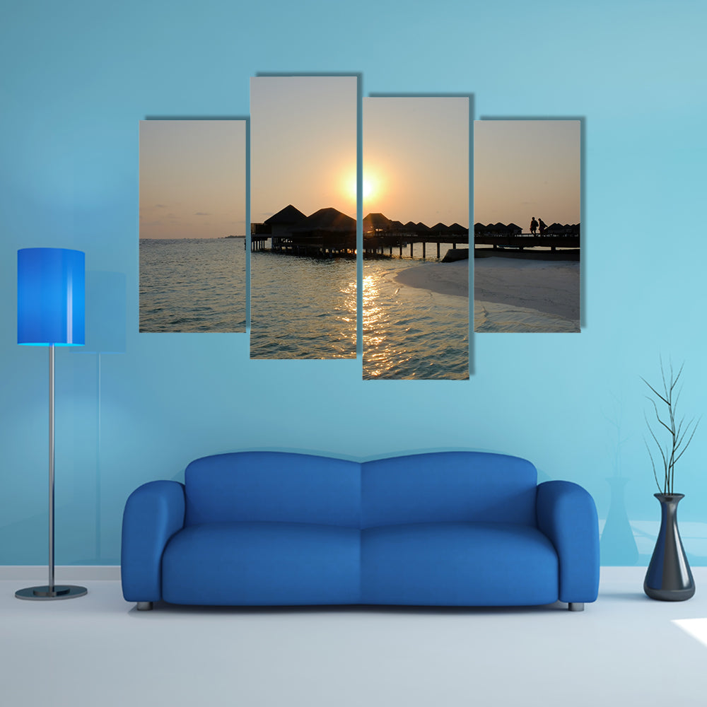 A Couple Enjoys At The Idyllic Sunset Stroll Along The Silhouetted Boardwalk Multi Panel Canvas Wall Art
