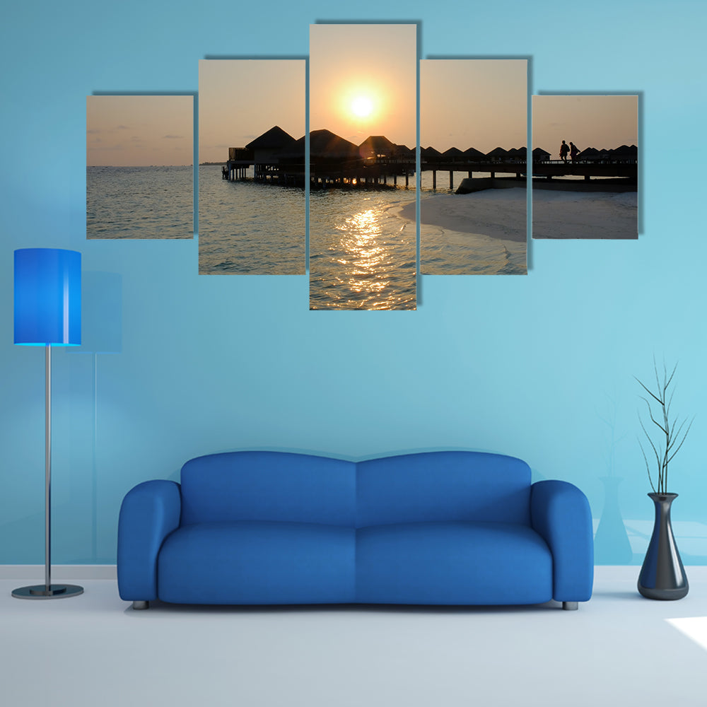 A Couple Enjoys At The Idyllic Sunset Stroll Along The Silhouetted Boardwalk Multi Panel Canvas Wall Art