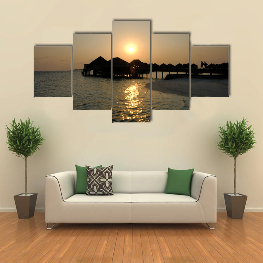 The Romance Of ACouple That EnjoyAn Idyllic Sunset stroll Multi Panel Canvas Wall Art