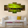 Intense northern lights (Aurora borealis) over Lake Laberge, Yukon Territory, Canada, with fall colored willows on lake shore Multi panel canvas wall art