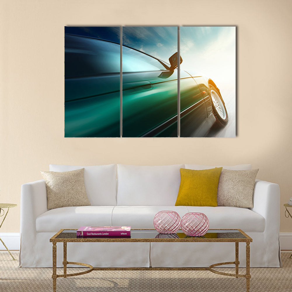 Blurred car on road and sky with clouds Multi panel canvas wall art