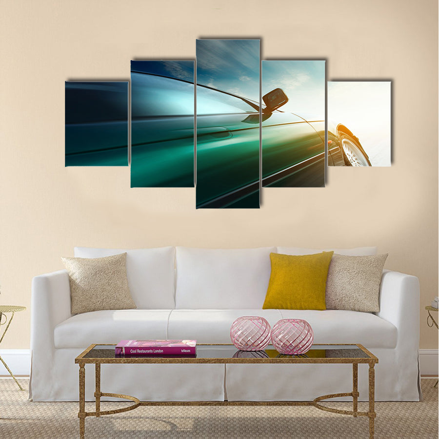 Blurred car on road and sky with clouds Multi panel canvas wall art