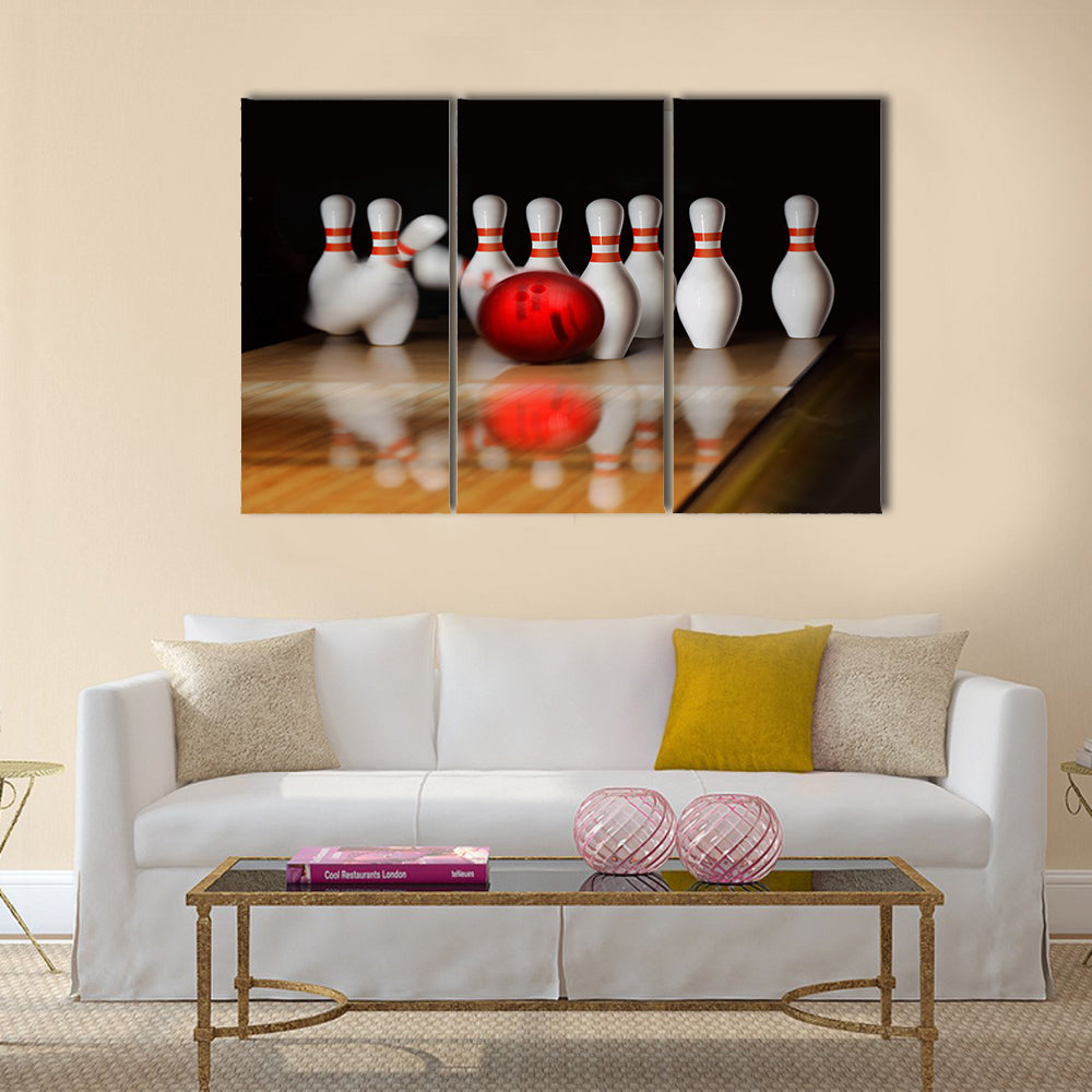 Orange ball does strike on tenpin bowling in skittle-ground Multi panel canvas wall art