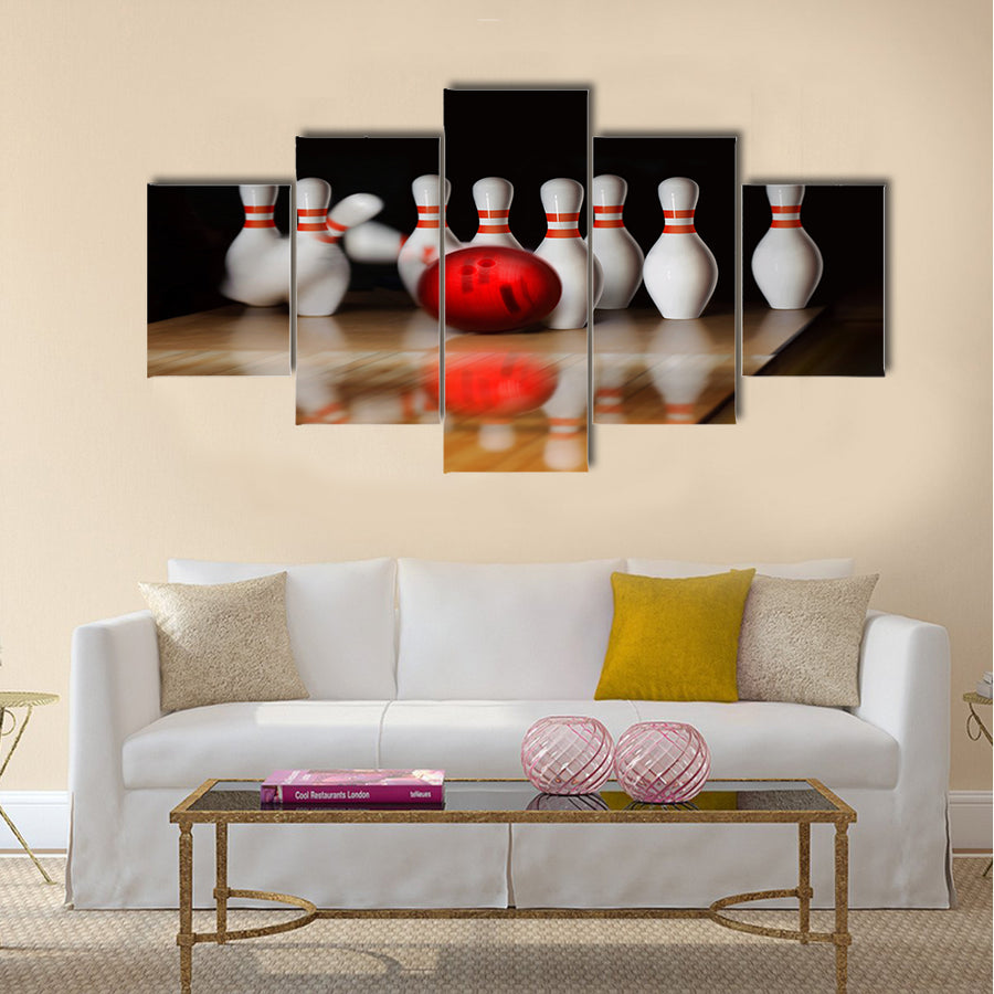 Orange ball does strike on tenpin bowling in skittle-ground Multi panel canvas wall art