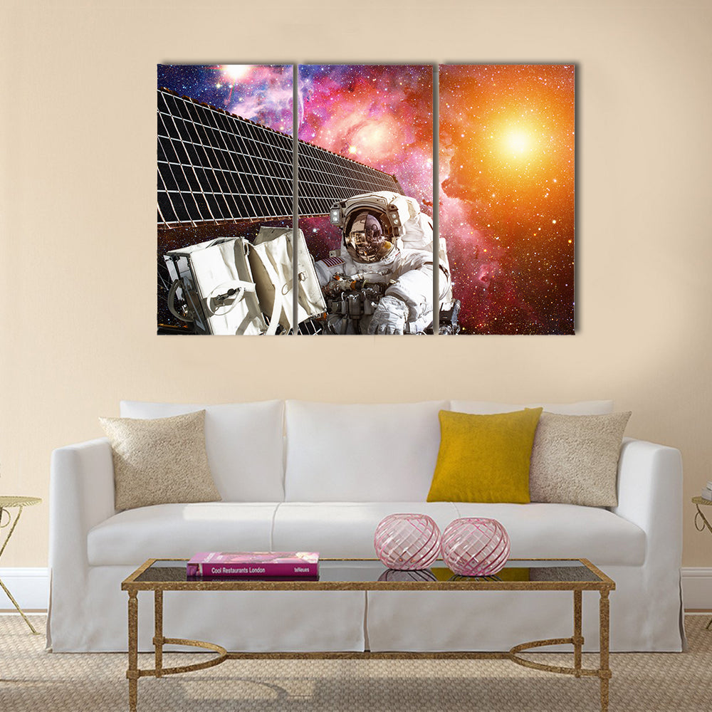 International Space Station and astronaut in outer space over the planet Earth Multi Panel Canvas Wall Art