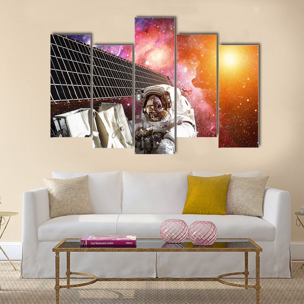 International Space Station and astronaut in outer space over the planet Earth Multi Panel Canvas Wall Art