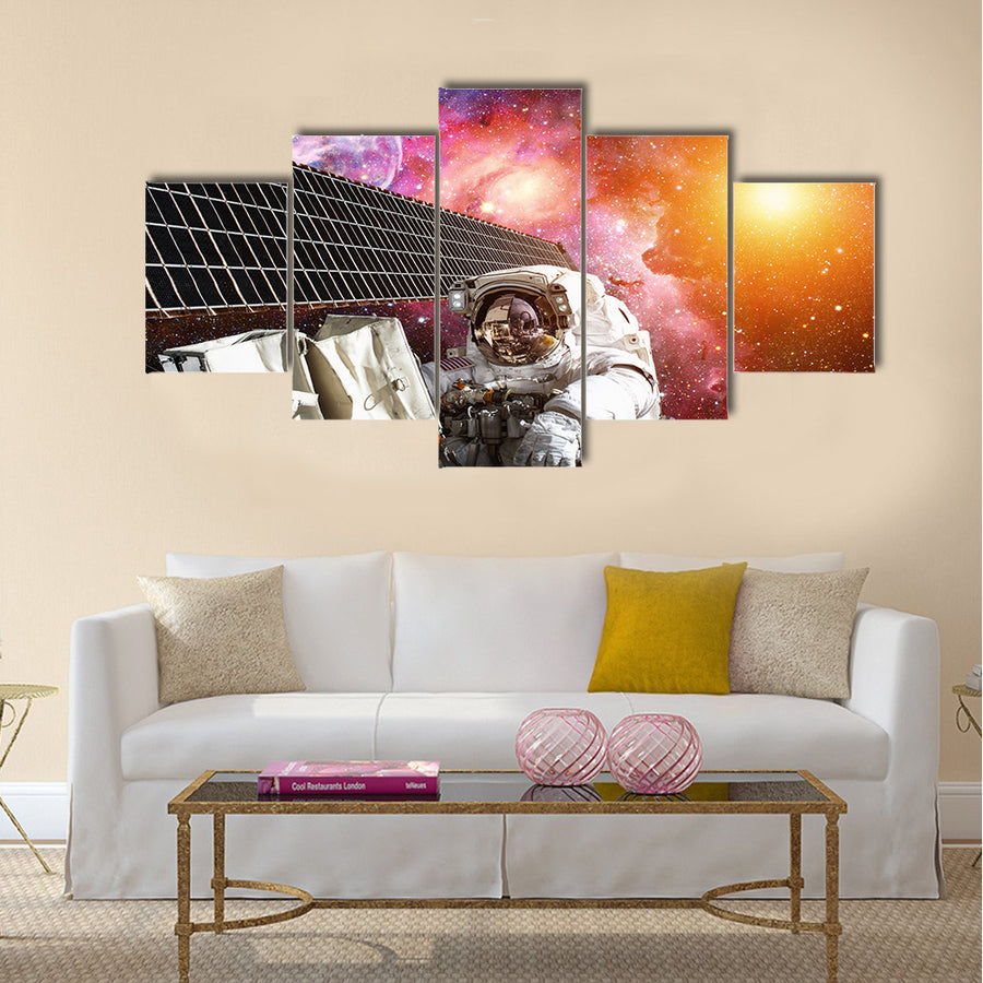 International Space Station and astronaut in outer space over the planet Earth Multi Panel Canvas Wall Art