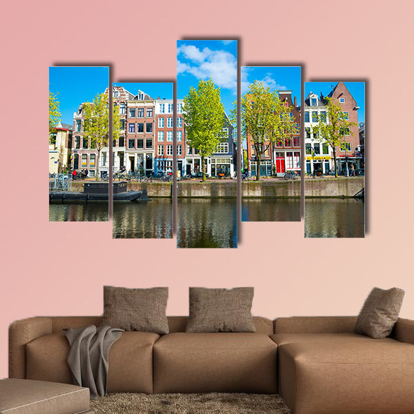 View of the ancient buildings, streets, people, embankments of Amsterdam multi panel canvas wall art