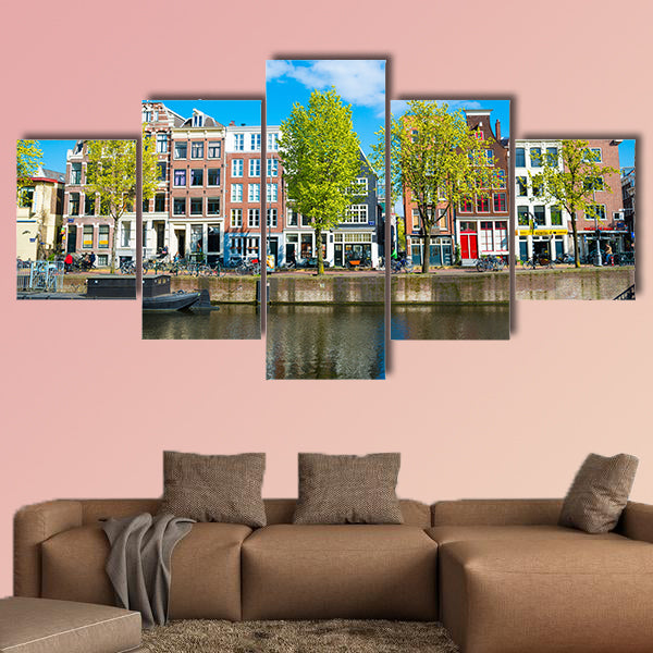 View of the ancient buildings, streets, people, embankments of Amsterdam multi panel canvas wall art