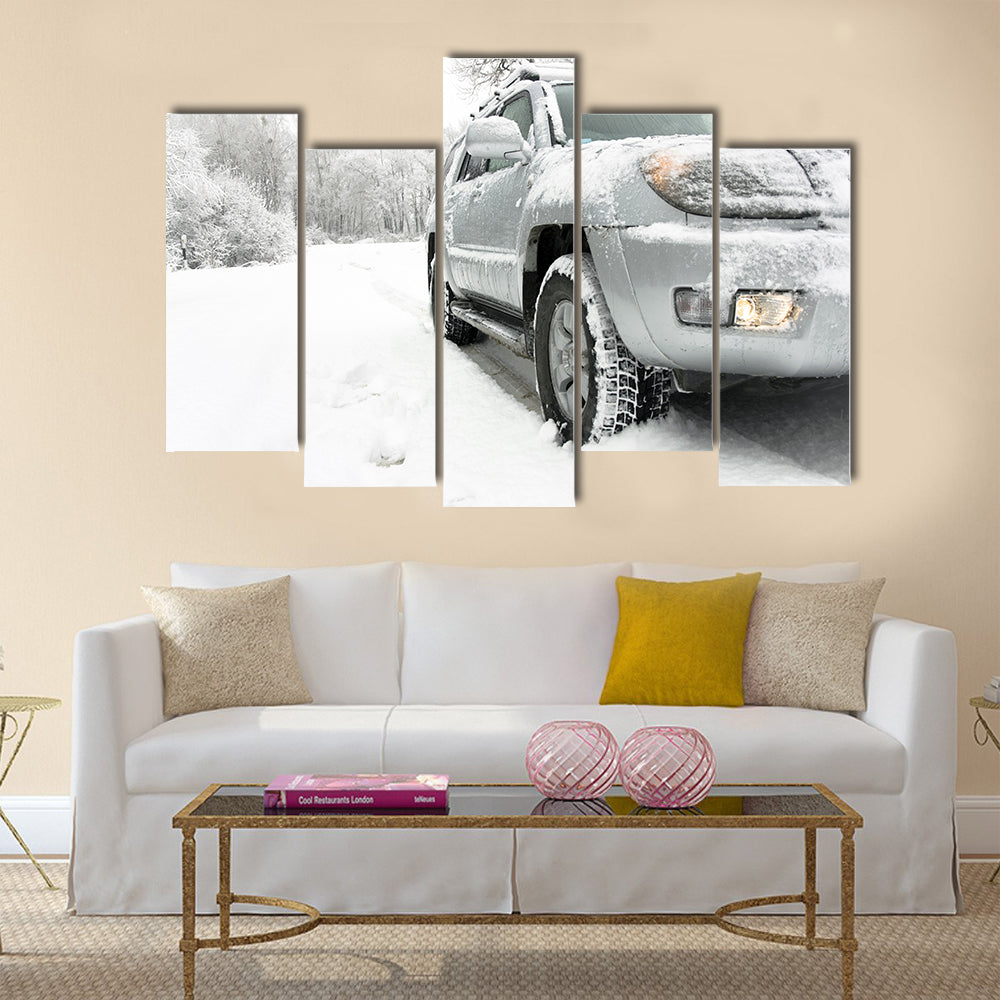 Snowy winter road behind an unrecognizable car Multi panel canvas wall art