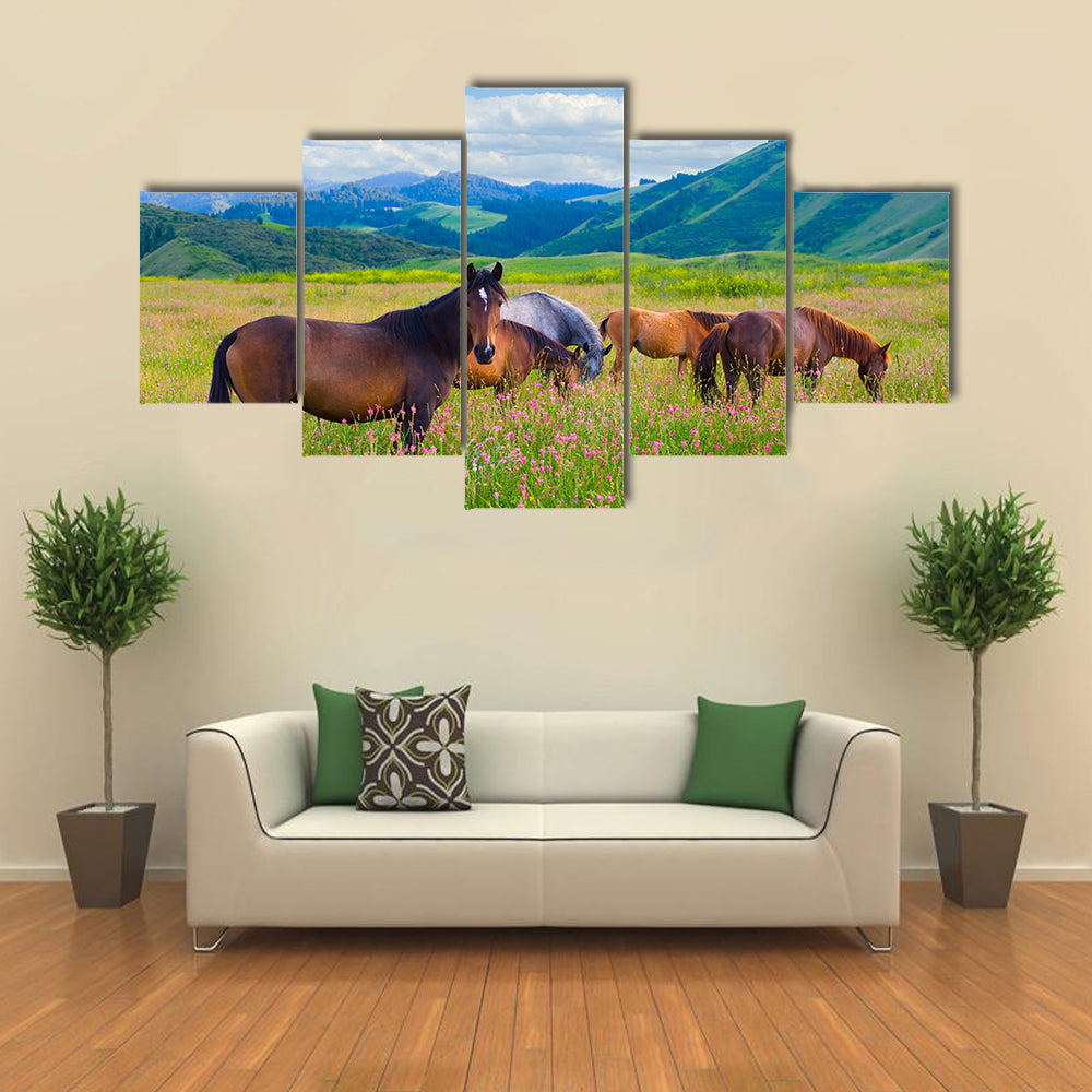 The herd of horses is grazed on a summer green meadow multi panel canvas wall art