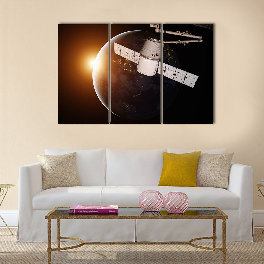 Satellite orbiting the planet Earth Multi Panel Canvas Wall Art