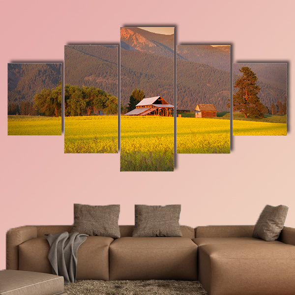 Rapeseed farm and barn in evening sun light Multi panel canvas wall art