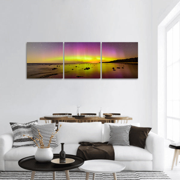 Intense northern lights over Baltic sea. rocky beach panoramic canvas wall art
