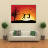 man and girl holding hands and jumping on hill near bare tree, orange background multi panel canvas wall art