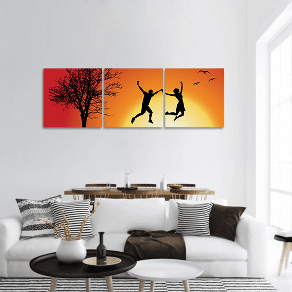Man and girl holding hands and jumping on hill bare tree panoramic canvas wall art