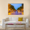 The evening walk along the illuminated Avenue with a view on the modern Clock Tower Multi panel canvas wall art