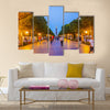 The evening walk along the illuminated Avenue with a view on the modern Clock Tower Multi panel canvas wall art